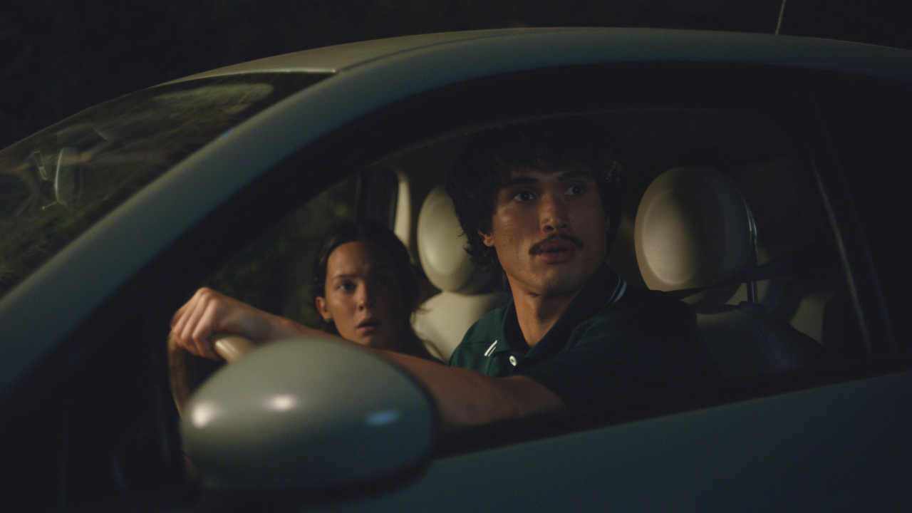 Ashley Miller (Cailee Spaeney) and Austin Davis (Charles Melton) sit in their car on Beef.