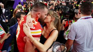 Taylor Swift and Travis Kelce kiss at the 2024 Super Bowl