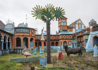Colourful building with statues and sculptures in garden
