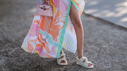 a woman wearing pastel coloured clothing and sandals - pastel pedicure
