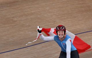 Canadas Kelsey Mitchell celebrates with a flag after taking gold in the womens track cycling sprint finals during the Tokyo 2020 Olympic Games at Izu Velodrome in Izu Japan on August 8 2021