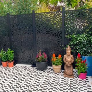 ornate garden fence in black with painted patio
