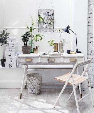 Office she shed ideas featuring a white desk and wooden chair in an all white scheme.