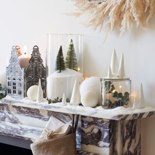 Marble decorated mantelpiece filled with Christmas decorations