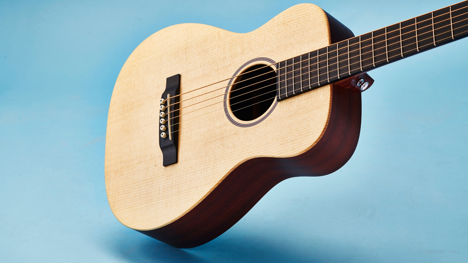 A Martin LX1E Little Martin on a blue background