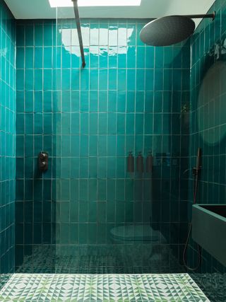 shower room with jade tiled walls and green patterned tiles on floor