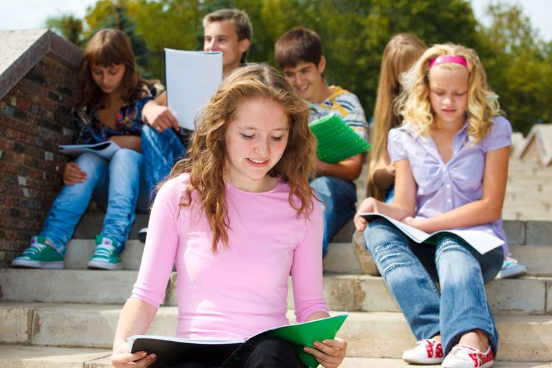 group of teens on steps studying