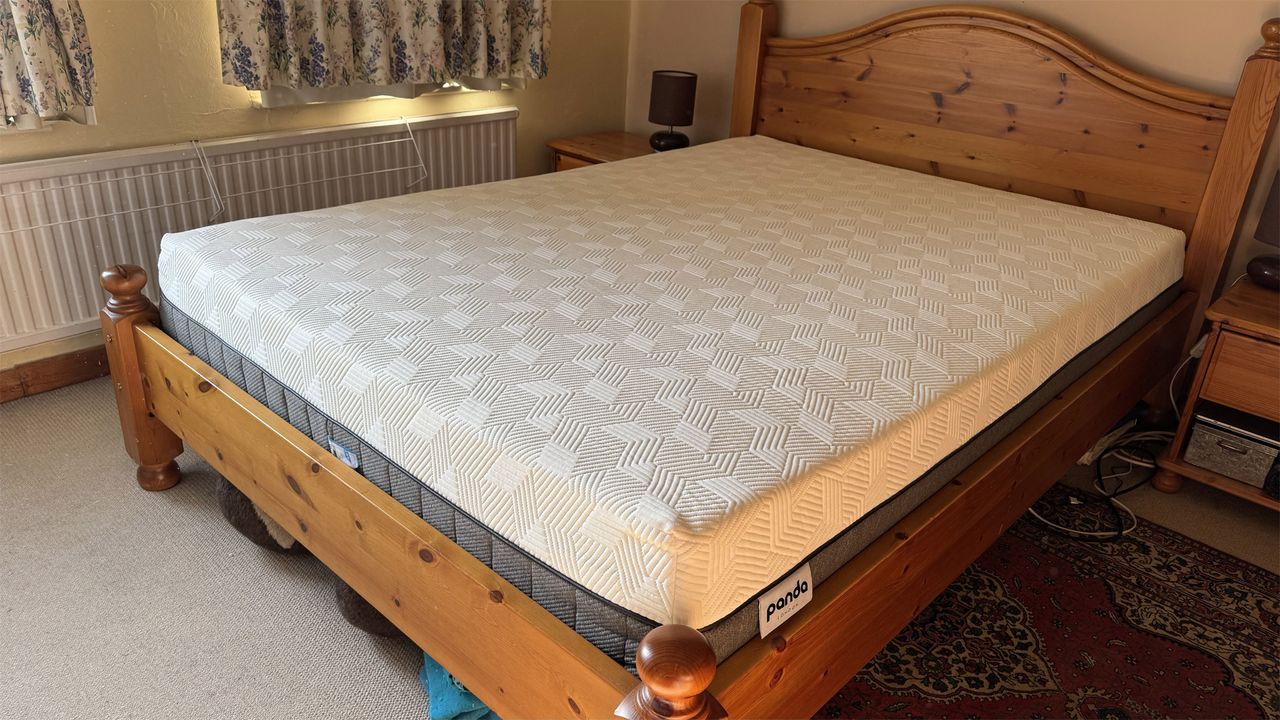 The Panda Hybrid Bamboo mattress on a wooden bed in a bedroom