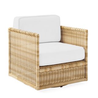 A Pacifica Swivel Chair in Light Dune wicker against a white background