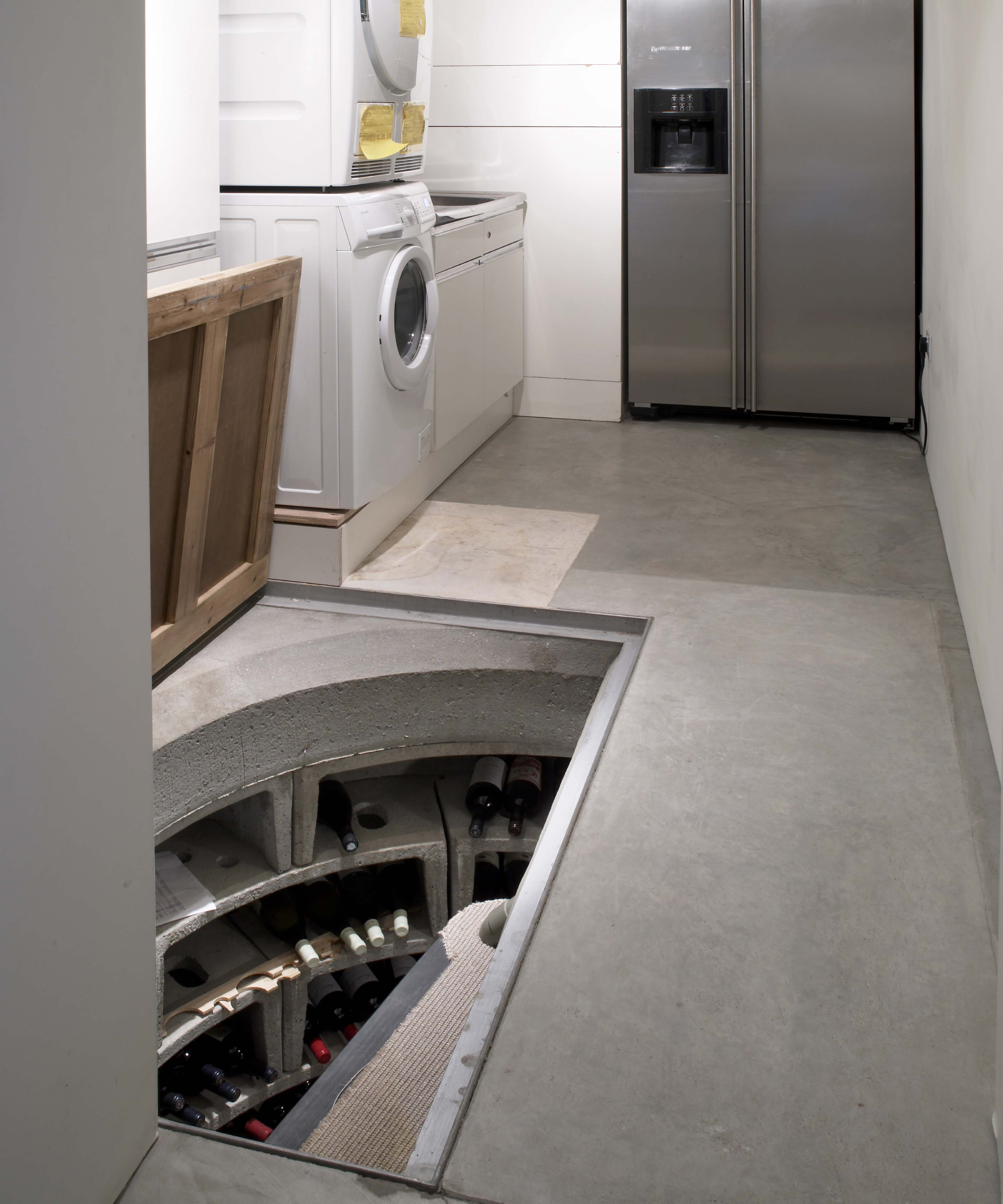 utility room with wine store built into the basement below, accessed via stairs from the utility room floor