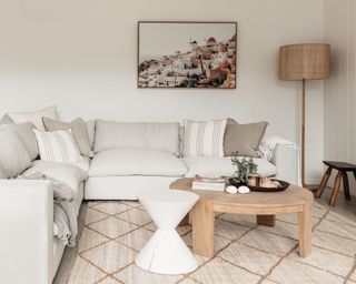 white sofa in neutral living space with rug and coffee table