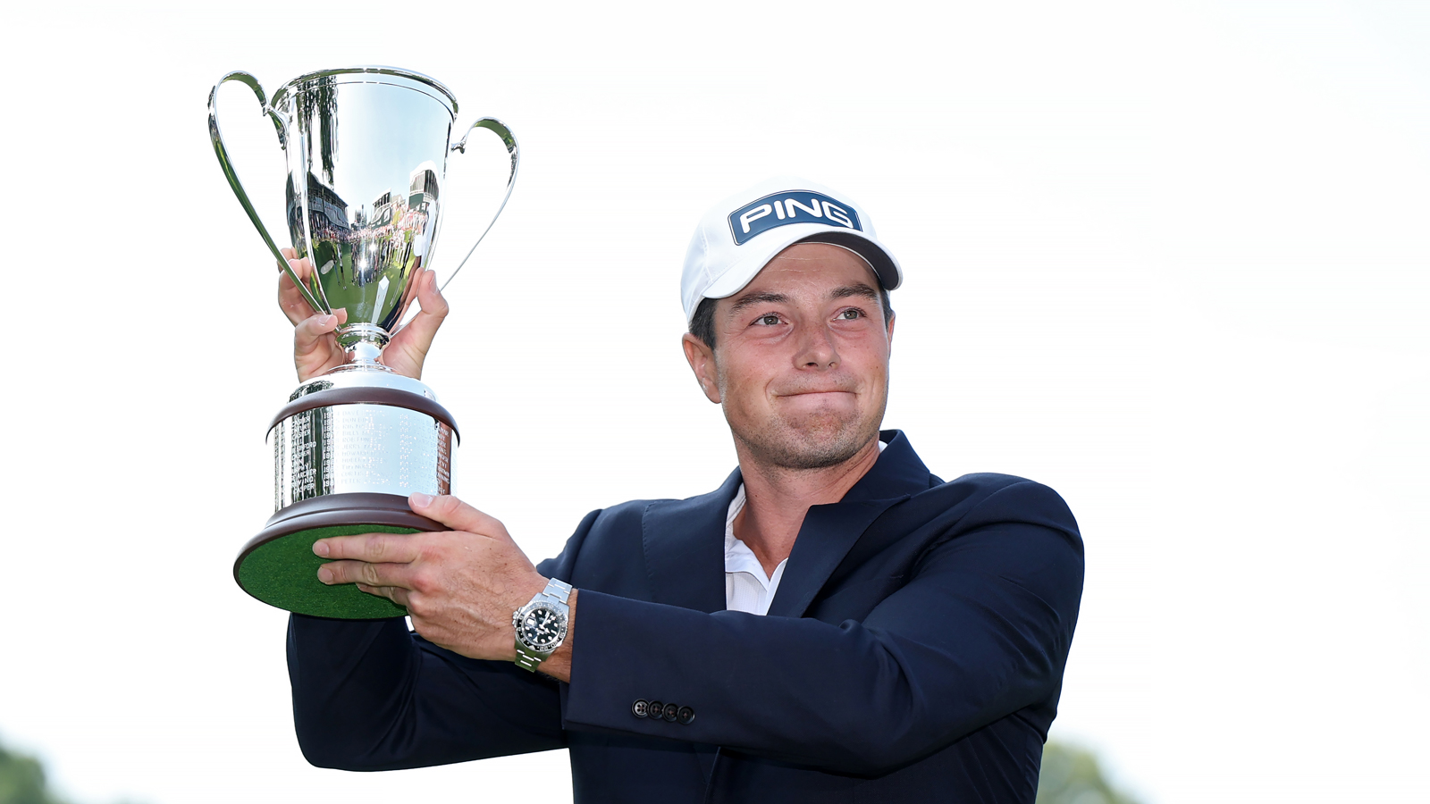 Viktor Hovland holds the Travelers Championship trophy