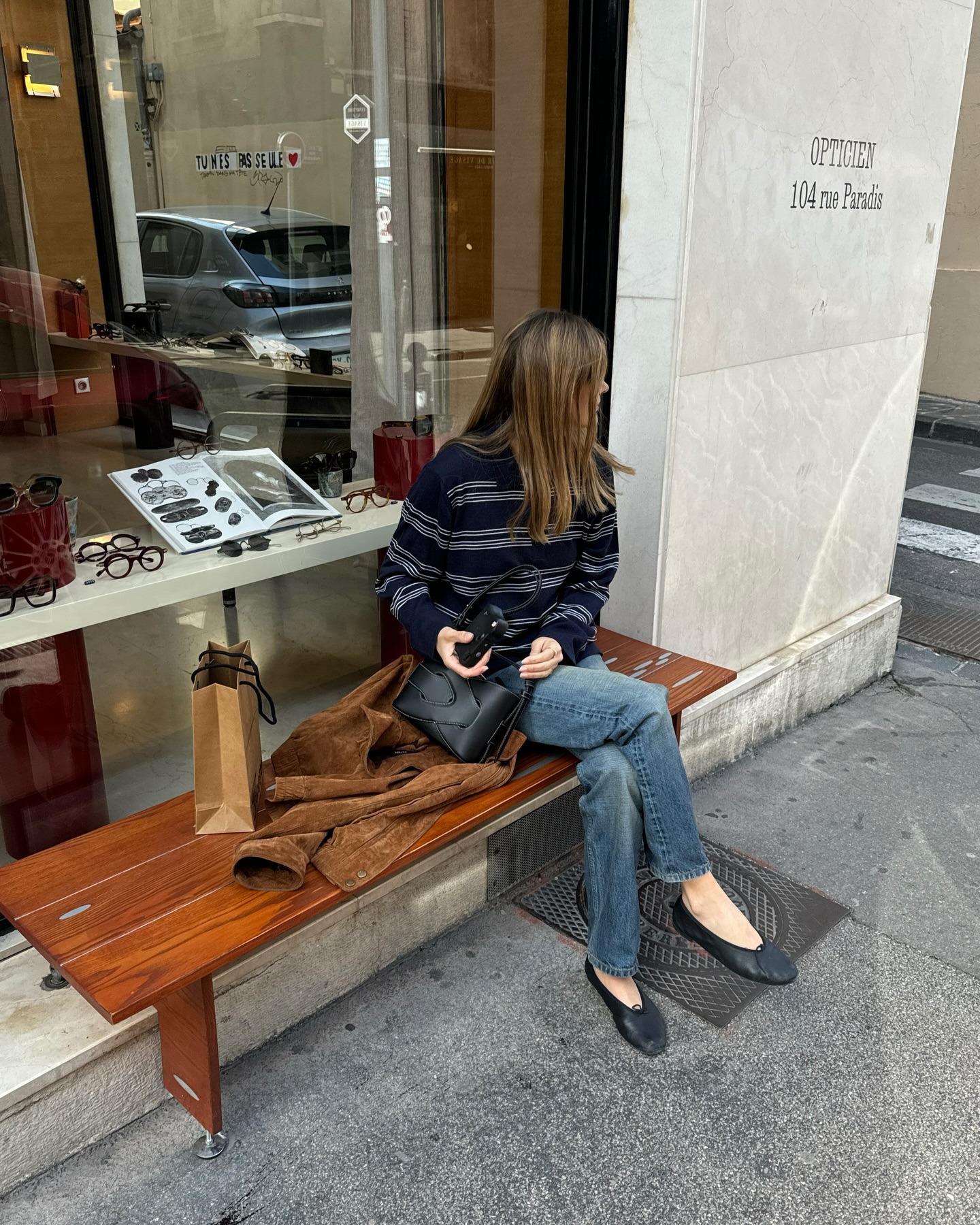 French girl @annelauremais wearing a striped sweater, jeans, and ballet flats in Paris.