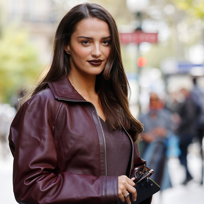 a beautiful brunette woman wearing burgundy leather jacket with matching burgundy lipstick - best burgundy lipstick