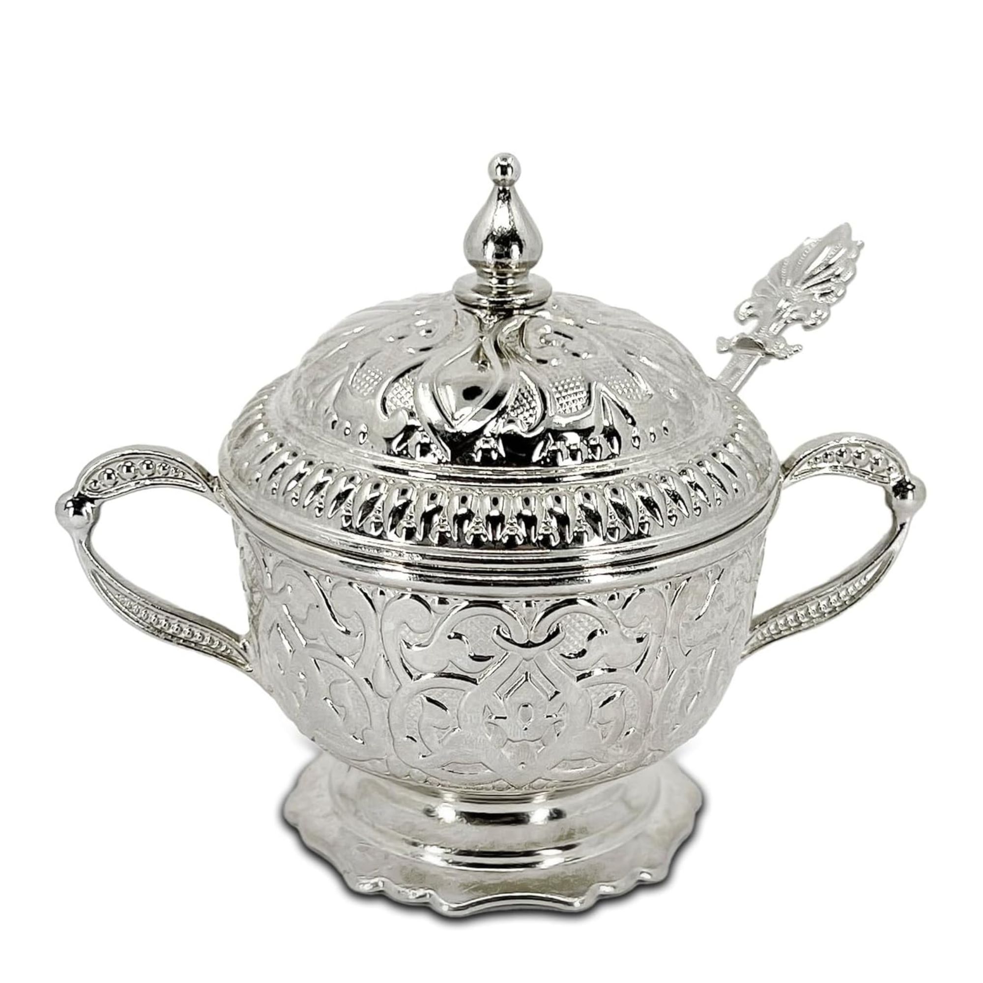 Embossed silver sugar jar with matching spoon