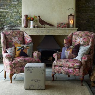 living room with floral print armchairs and fireplace