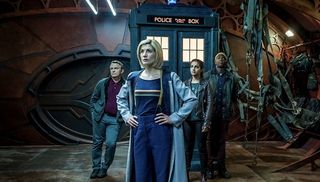 Jodie Whittaker as Doctor Who standing in front of the TARDIS