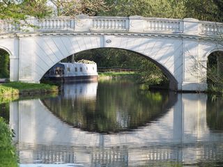 A white bridge over the Grand Union Canal.