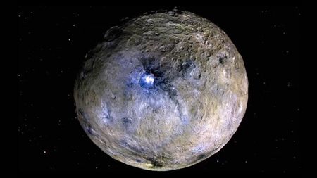 a silver-and-grey round rock in space