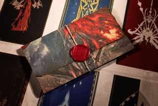 Photograph of wax sealed envelope on backdrop of house sigils, part of Fluid's influencer kit for FFXVI