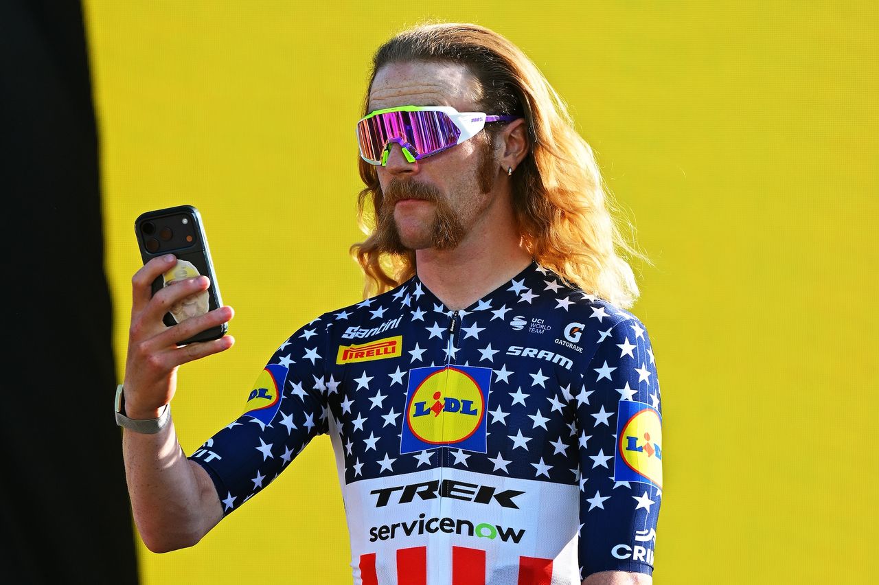Quinn Simmons takes a photo from the stage wearing his stars and stripes jersey