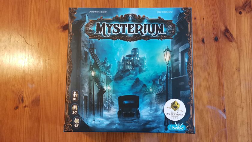 The Mysterium box on a wooden surface, seen from above