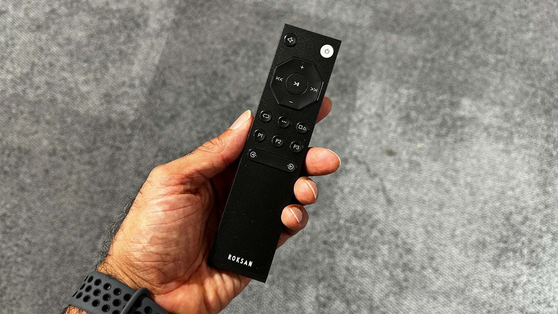 Roksan Caspian 4G Streaming Pre-Amplifier/Caspian 4G Power Amplifier remote control held in hand