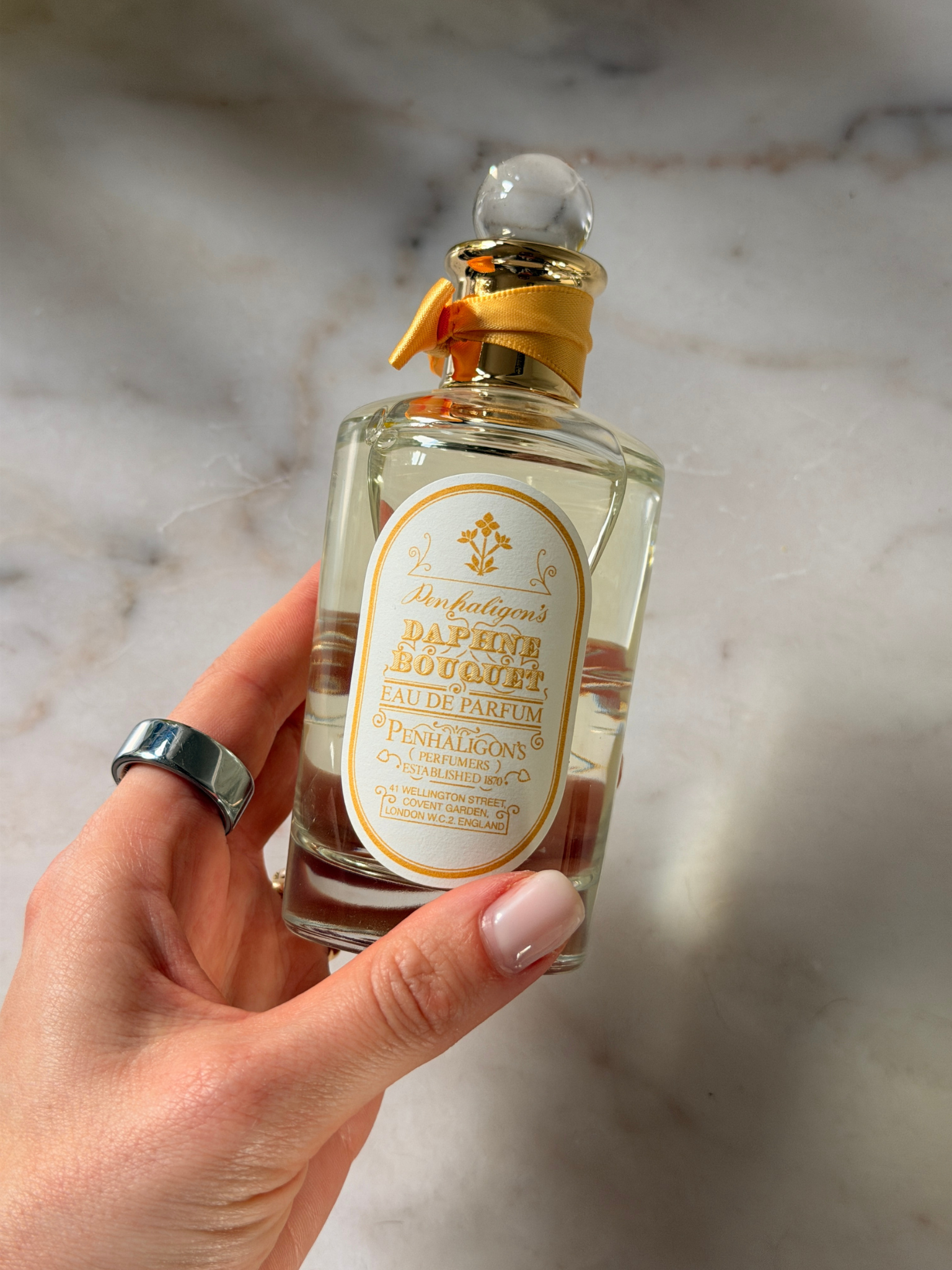 Grace holding a bottle of Penhaligon's perfume