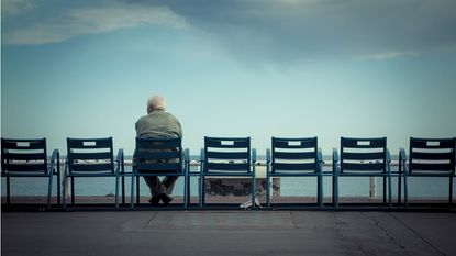 Man sitting alone looking out to sea 