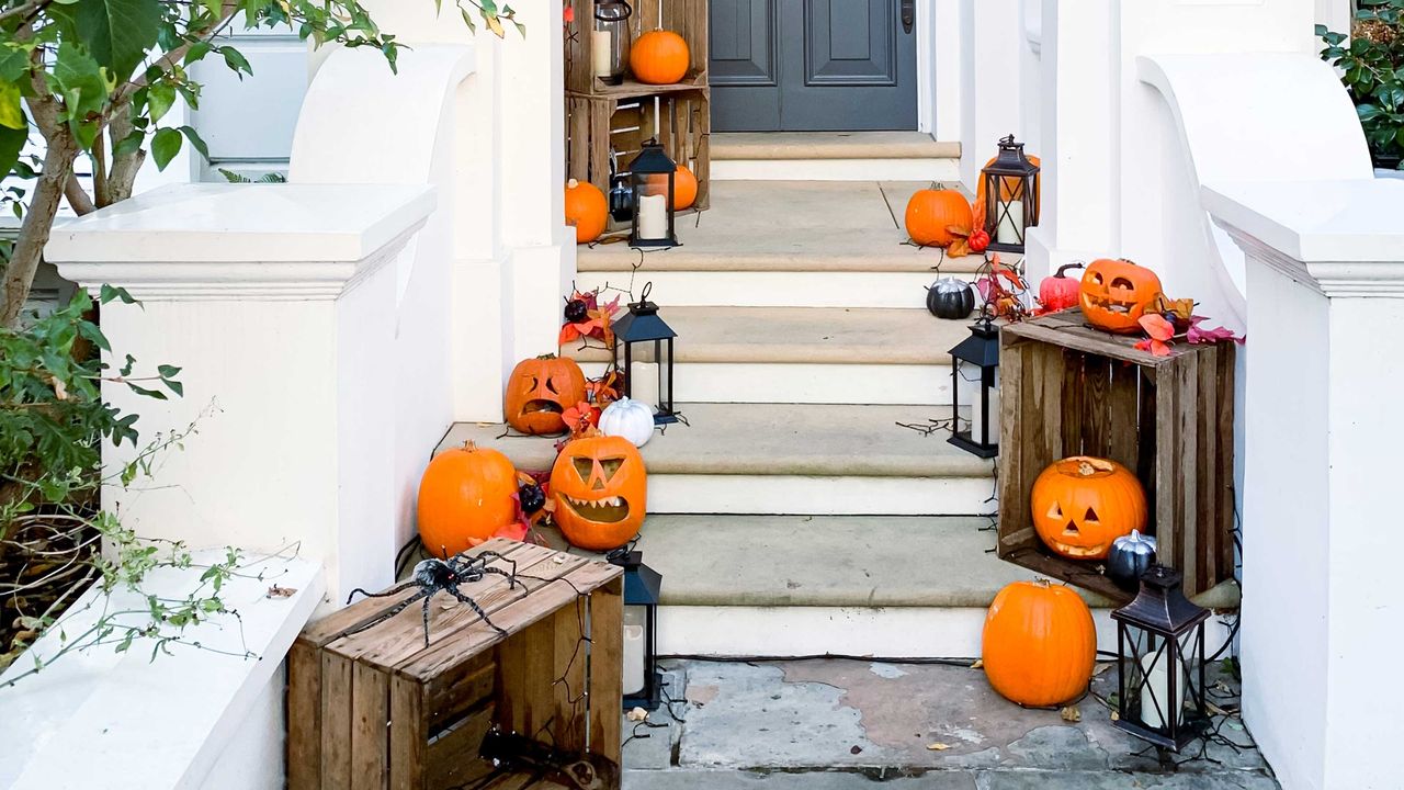 jack o&#039; lanterns and spider decorations on doorway steps