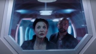 Shohreh Aghdashloo looking out a window with concern in The Expanse.