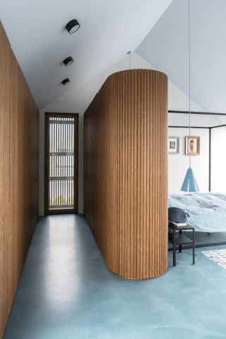 modern bedroom with large curved wood built in wardrobe