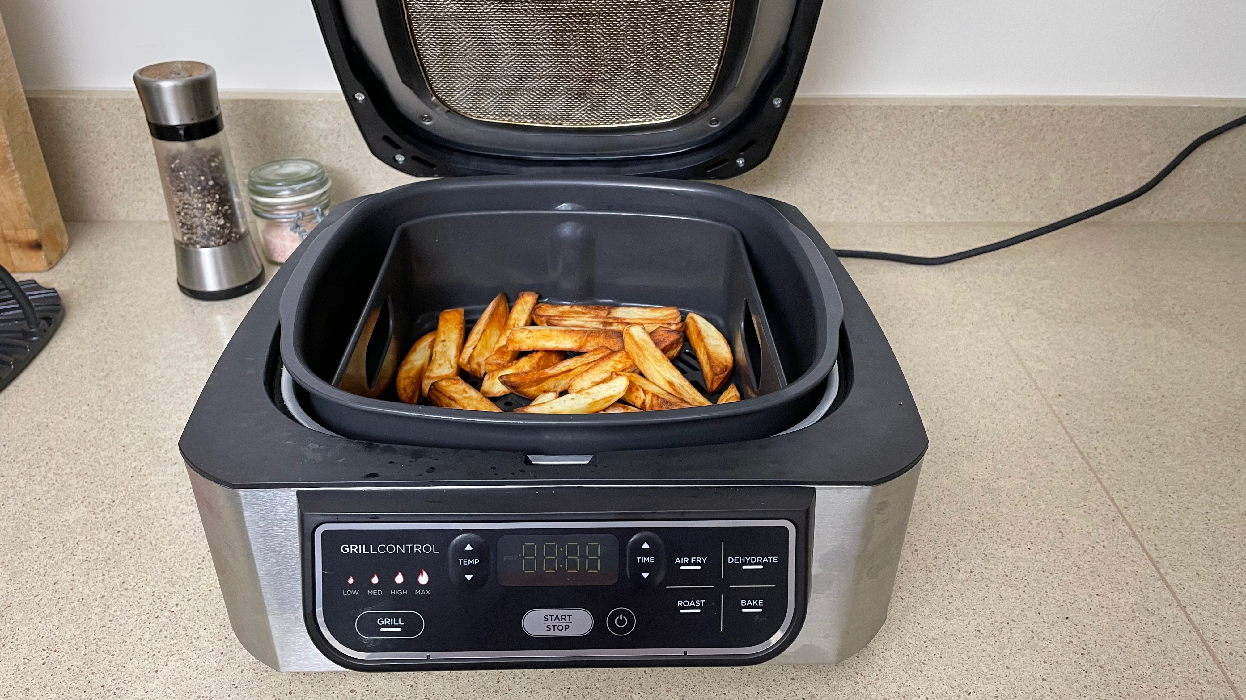Ninja Foodi Health Grill & Air Fryer with cooked fries inside