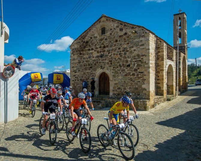 The men race past a church