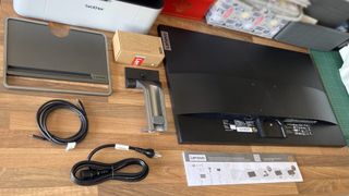 Lenovo L32p-30 32" 4K UHD monitor unboxed onto a desk with all parts displayed neatly