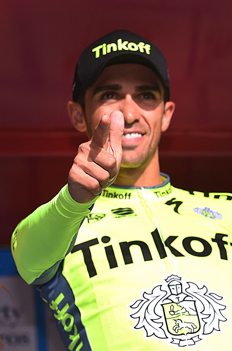 Alberto Contador doing his signature 'pistolero' victory salute on the podium