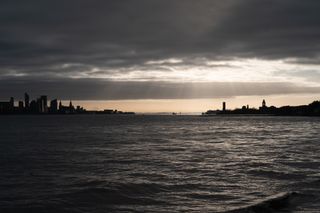 The sun breaking through the clouds over the Liverpool and Birkenhead skyline