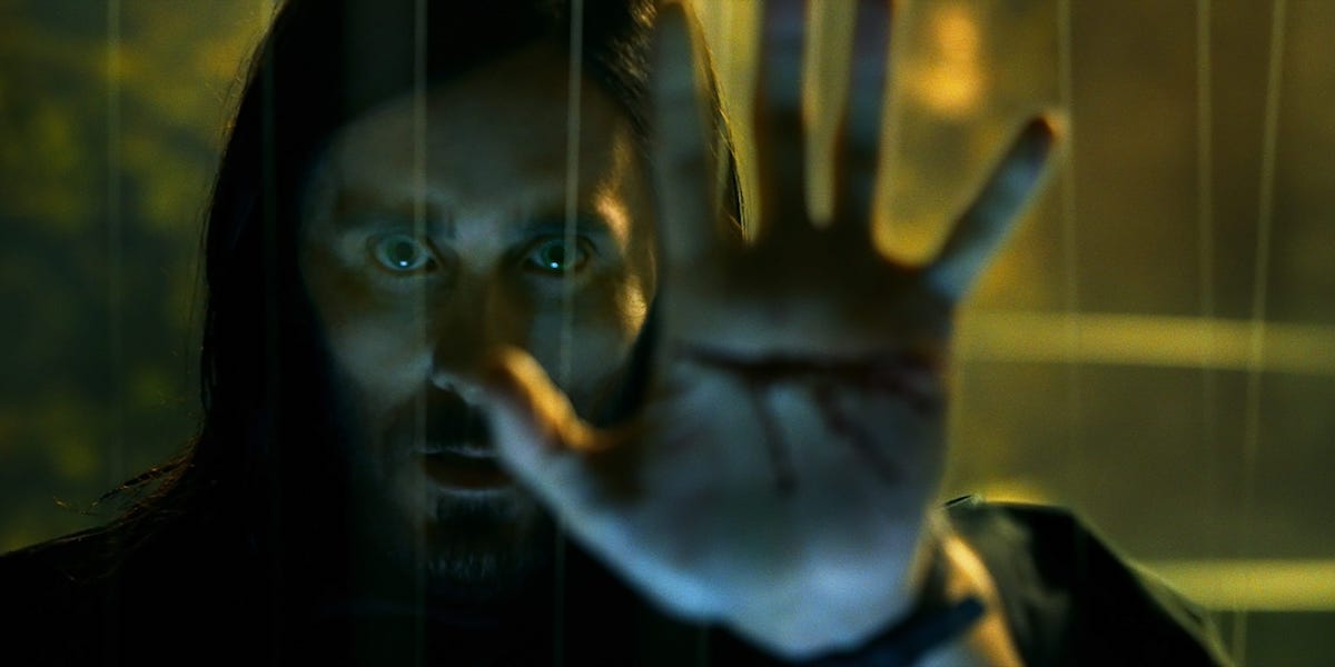 Michael Morbius (Jared Leto) holds his bleeding hand up to a window in &#039;Morbius&#039;