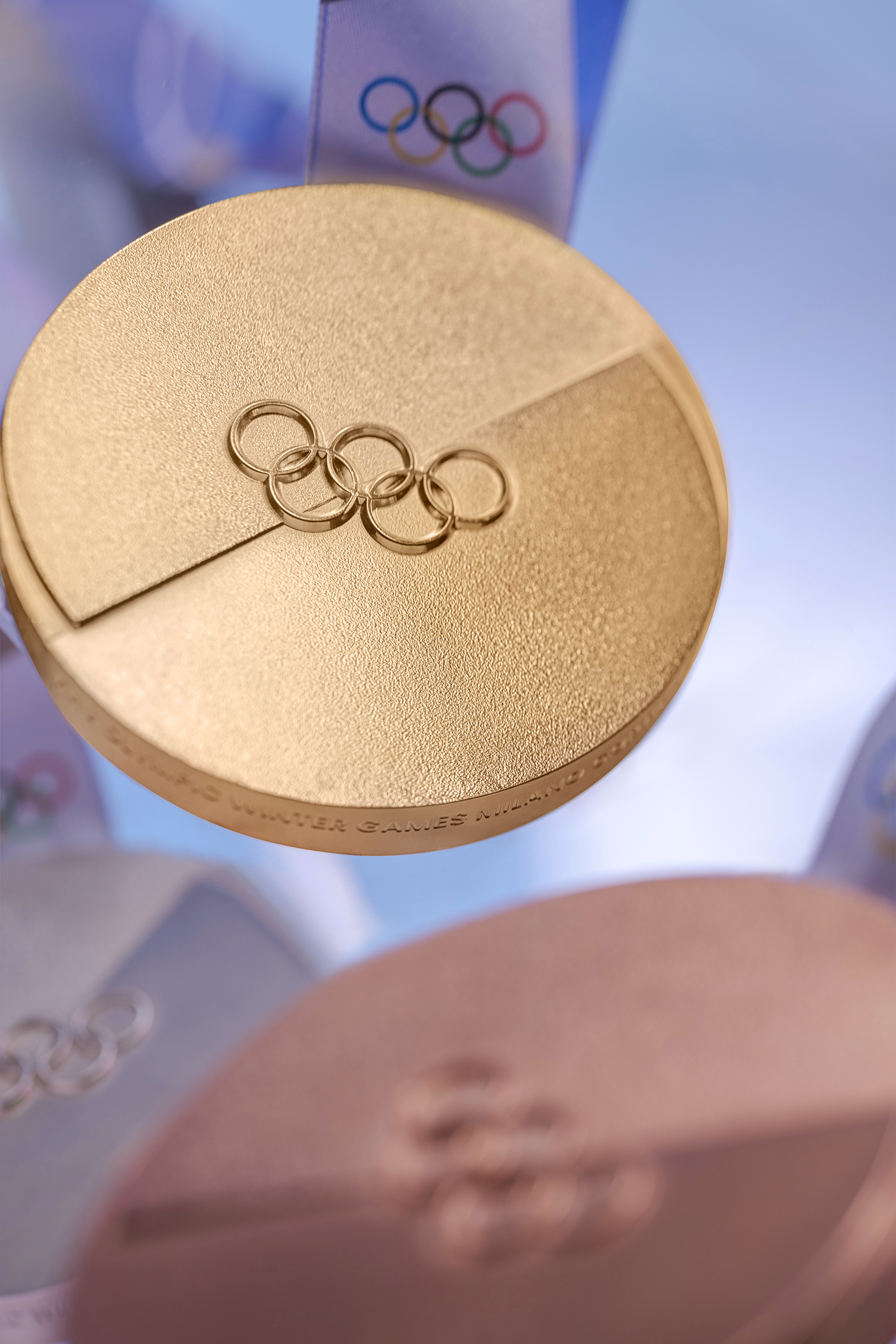 Medals for Winter Olympics 2026: gold, silver and bronze, with blue ribbon