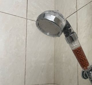Shower head with filtrating beads, turned on