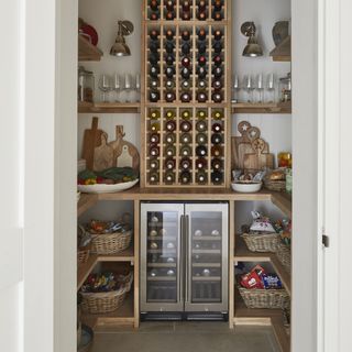 Walk-in pantry with wine fridge and bottle storage