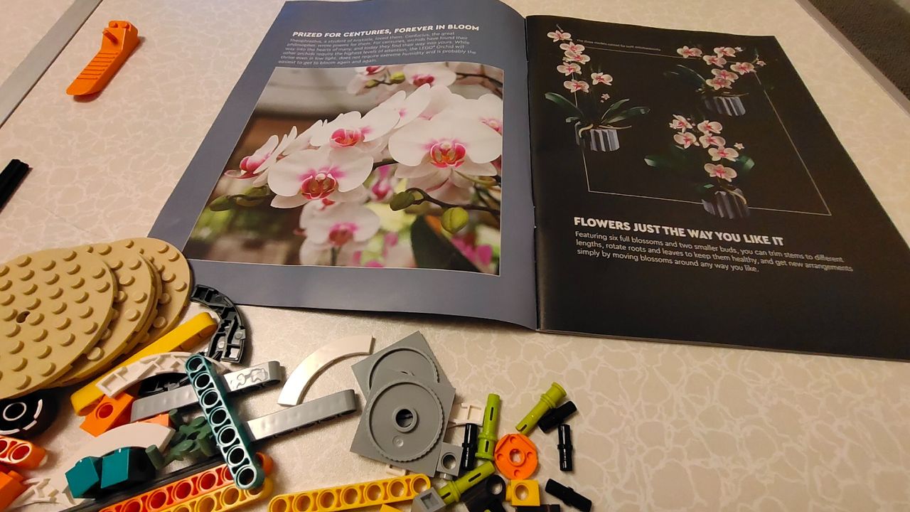 Lego Orchid 10311_Open instruction booklet and selection of Lego pieces.