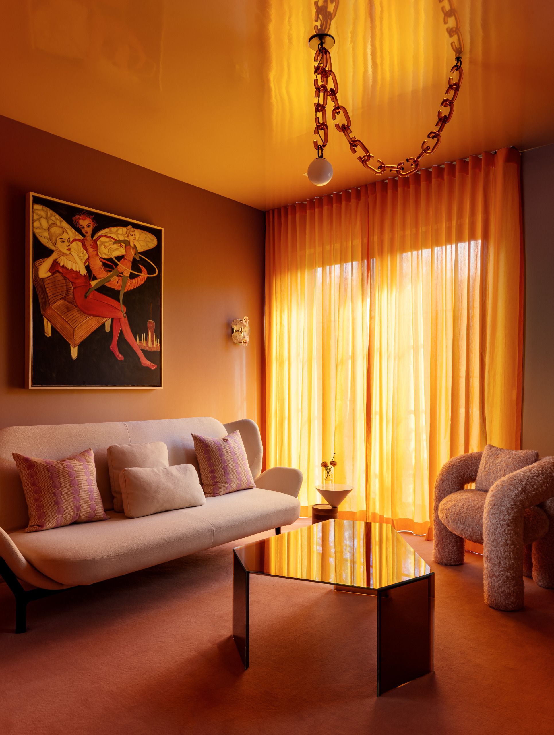 A contemporary living space/nook decorated in a yellow palette with a high-gloss ceiling