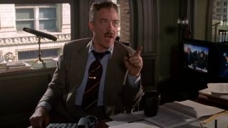 J.K. Simmons sits at a cluttered desk barking orders in Spider-Man.