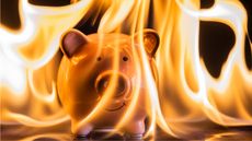 A piggy bank is engulfed in flames but not distressed.