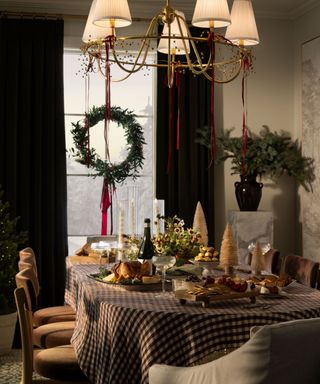 Dining room decorated for the holidays with a wreath at the window