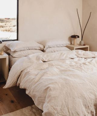 Oatmeal Bedding Bundle on a bed against a cream wall.