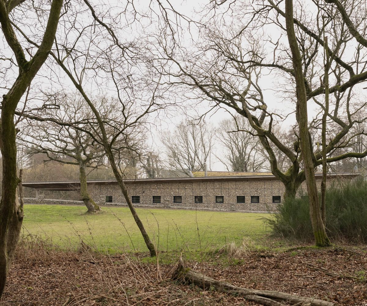 The long side of a house made of a gabion wall