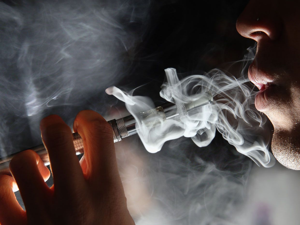 LONDON, ENGLAND - AUGUST 27:In this photo illustration, a man smokes an E-Cigarette at the V-Revolution E-Cigarette shop in Covent Garden on August 27, 2014 in London, England. The Department