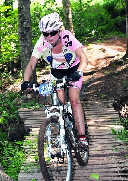 Lindsey Prososki (15-18) rides over a bridge.